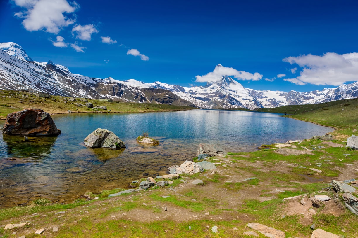 Icy blue waters of a fjord with mountains in the background